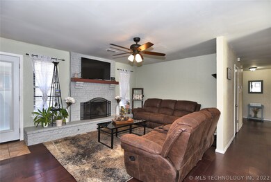 Fireplace in the living room with updated wood flo