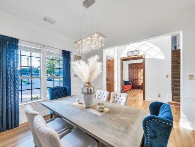 Dining room featuring ornamental molding, an inviting chandelier, and light wood-type flooring