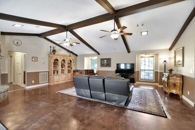 View of the den from entry.  Stained concrete floors in this spacious living area