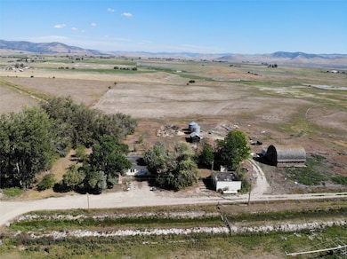 Aerial view of property's location featuring rural landscape and a mountainous background