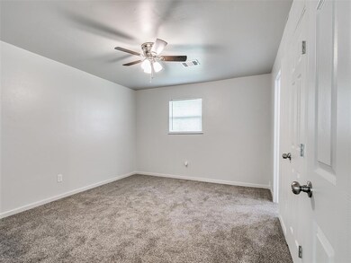 Spare room with light carpet and ceiling fan