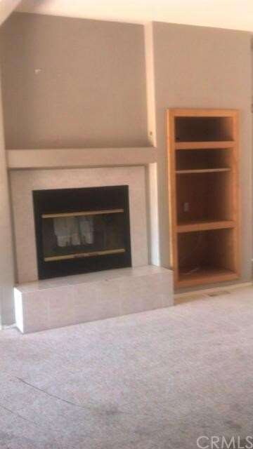 Fireplace from family room side, with built-ins fo