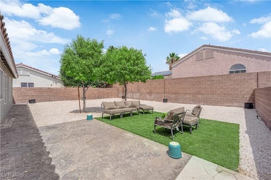 Back of house featuring a fenced backyard, stucco