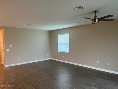 Unfurnished room with ceiling fan and dark hardwoo