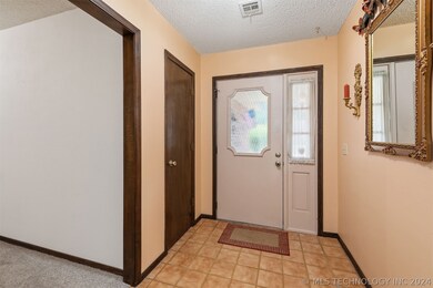 Spacious tile entrance with coat closet.