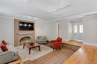 Sunken family room with brick fireplace and brick