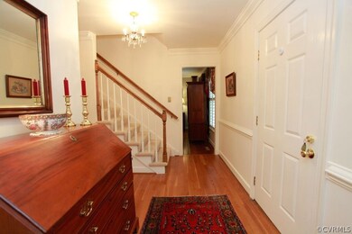 Beautiful foyer with wood floors and coat closet.