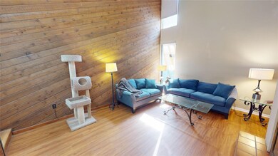 Living room with wood walls, wood-type flooring, a
