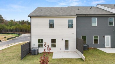 Rear view of property with a patio area and a shingled roof