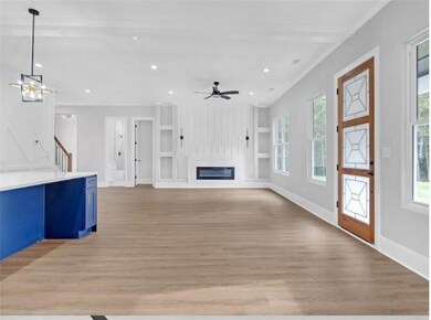 Unfurnished living room with stairway, baseboards,