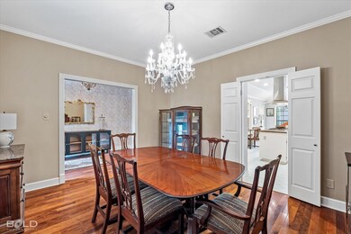 Dining room featuring wood-type flooring, a notabl