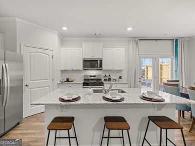 Sudbury townhome kitchen with granite countertops and white cabinets