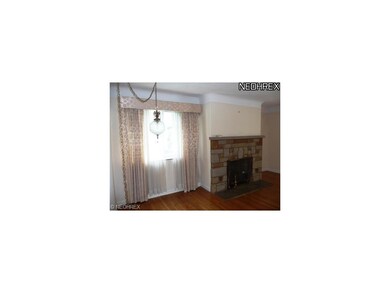 Spacious living room with hardwood floors and bric
