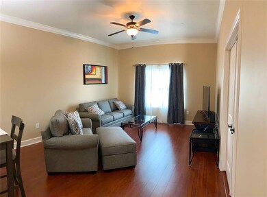 This modern living room with neutral walls, hardwo