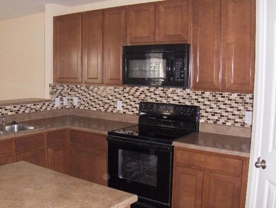 Kitchen with upgraded backsplash and island.