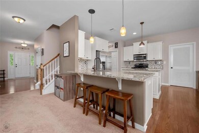 Kitchen opens to the extra large sunroom as well