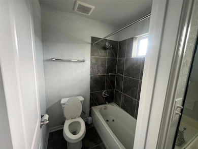 Bathroom with tile patterned flooring and shower 