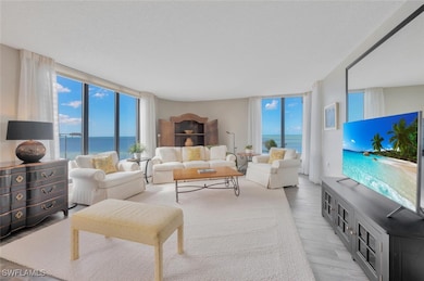 Living room featuring expansive windows, hardwood / wood-style floors, a wealth of natural light, and a water view