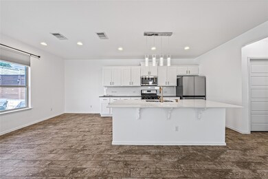 Kitchen featuring a sink, visible vents, stainles