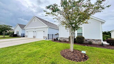 View of front of house with a front lawn and a gar