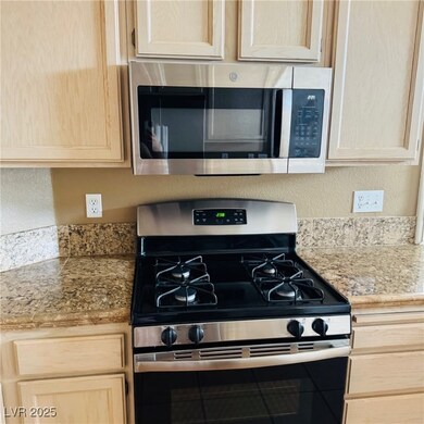 Kitchen featuring stainless steel appliances, tile