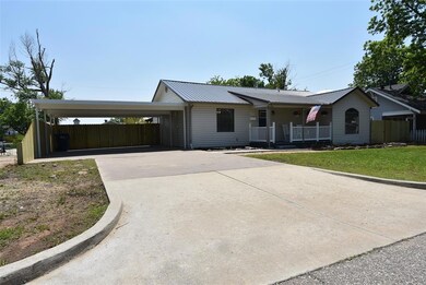Ranch-style house featuring a front yard, covered 