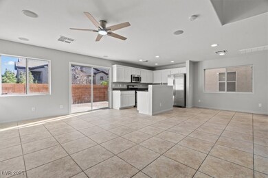 Unfurnished living room with ceiling fan, light ti