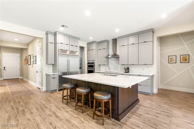 Kitchen featuring gray cabinets, stainless steel a