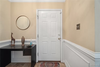 Entryway featuring crown molding