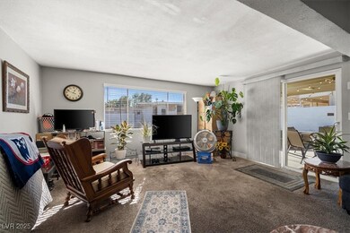 Carpeted living room featuring a textured ceiling