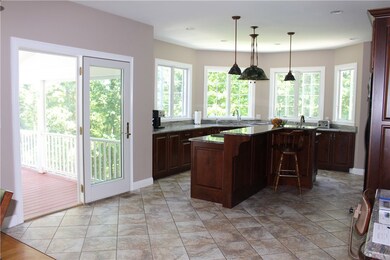 Open concept kitchen that leads to the enclosed de
