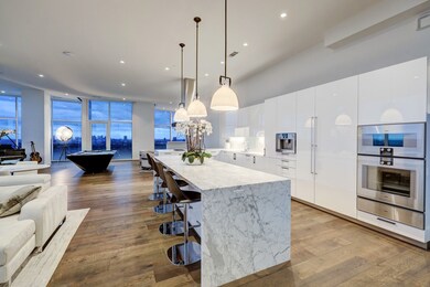 Oversized marble island with dual waterfall sides.