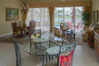 Dining area with baseboards, an inviting chandelie