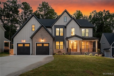 Modern inspired farmhouse featuring a lawn, covere