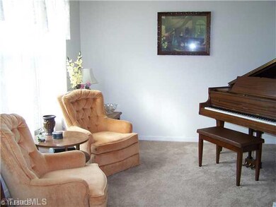 Living Room. To the left of the foyer is the bright living room, perfect for a grand piano.