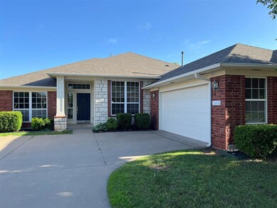 Ranch-style home with a front yard and a garage