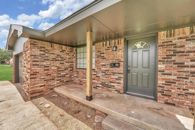 View of front entry with covered porch and wood posts