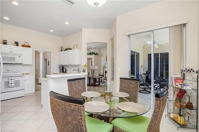 Dining space with light tile patterned floors, a c