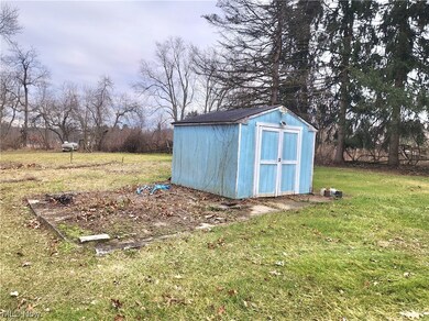 View of shed / structure with a lawn