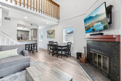 Living area with wood finished floors, a fireplace
