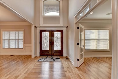 Foyer featuring crown molding, baseboards, french 
