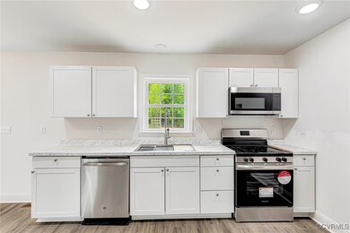 Kitchen featuring light wood finished floors, a si