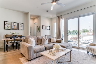 Living room featuring ceiling fan and light hardwood / wood-style flooring