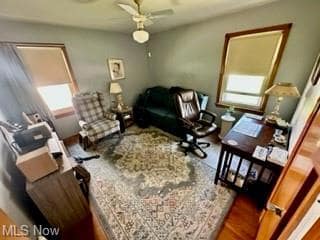 Living room with hardwood floors and ceiling fan