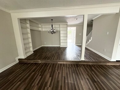 Interior space with a textured ceiling, dark wood-
