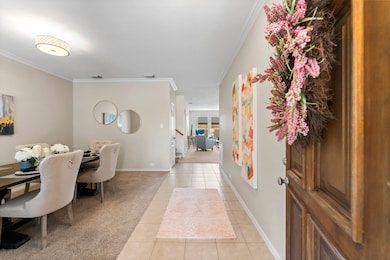 Spacious foyer is light and bright with formal din
