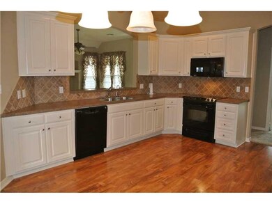 Kitchen View 1. Beautiful wood floors.