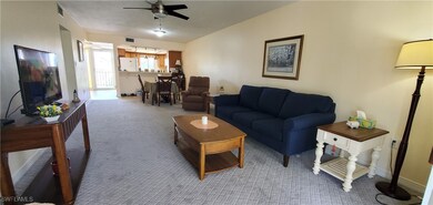 Living room featuring ceiling fan and light colore