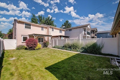 Back of property featuring a pergola, a fenced backyard, and a gate