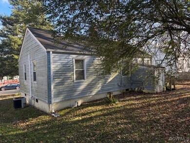 View of home's exterior with a lawn and central AC